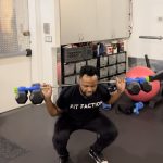 man doing barbell squats with Dualbell